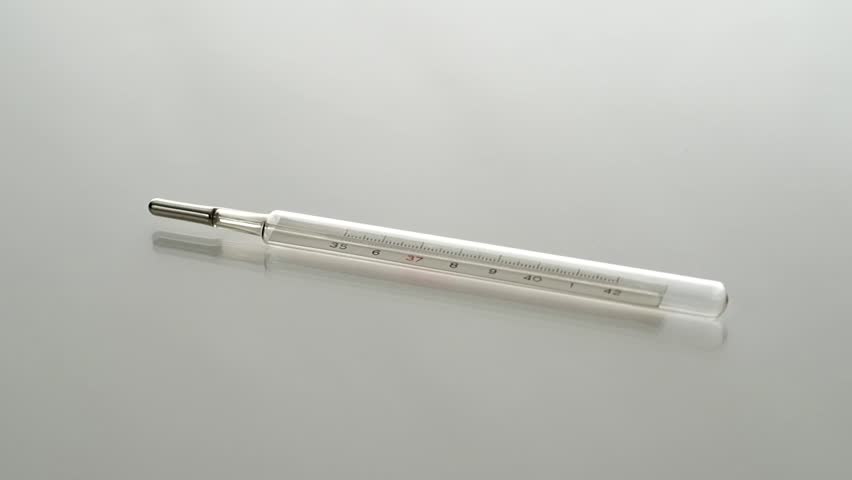 Glass mercurial thermometer rotating on a display table