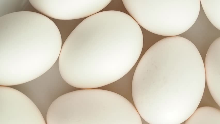 Rotating white fresh eggs