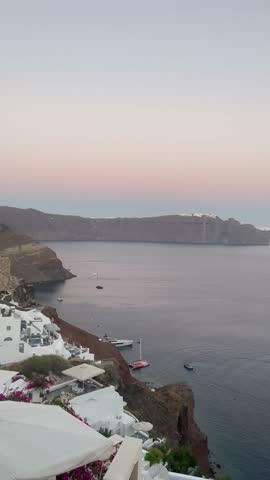 Sunset view of Santorini, Greece. Pastel Summer scenery of the gorgeous sea and sun.