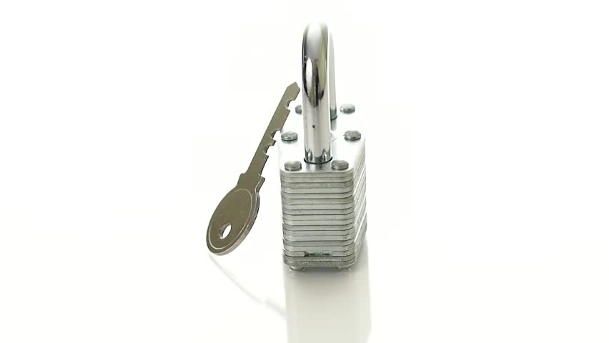 Padlock and a key rotating a pure white background