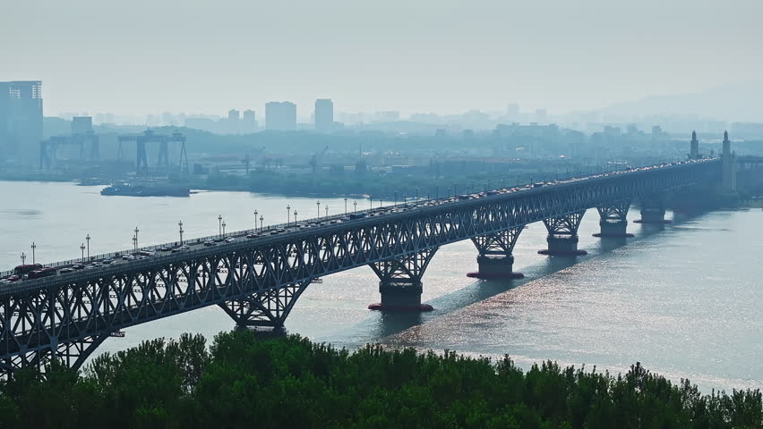 Famous Yangtze River Bridge and modern city skyline in sunrise view in Nanjing, China