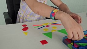 A child girl with glasses assembles a colorful puzzle symbolizing public awareness of autism  - Powered by Shutterstock - Get 15% off with code: PIKWIZARD15