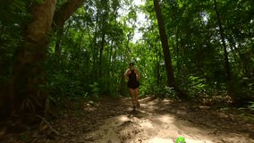 Caucasian athletic woman running in tropical rainforest in Thailand in slow motion - Powered by Shutterstock - Get 15% off with code: PIKWIZARD15