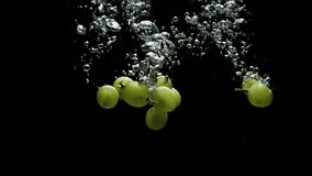 grapes in water with bubbles on black background and in slow motion - Powered by Shutterstock - Get 15% off with code: PIKWIZARD15