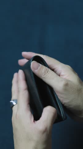 Businessman showing an empty wallet, highlighting financial struggles and the absence of money