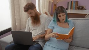 Pregnant woman reading book on couch with man using laptop in living room - Powered by Shutterstock - Get 15% off with code: PIKWIZARD15