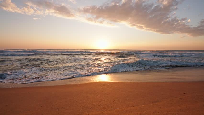 Surface of beautiful sea with small golden waves of sunrise slide. Large disk of sun rises above sea, sunny path through water. Relax. Freedom nature concept. Golden light of sea panorama