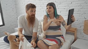 Couple sharing a joyful video call in bedroom while showing a baby item and holding a stuffed kangaroo, pregnant woman and happy man at home - Powered by Shutterstock - Get 15% off with code: PIKWIZARD15