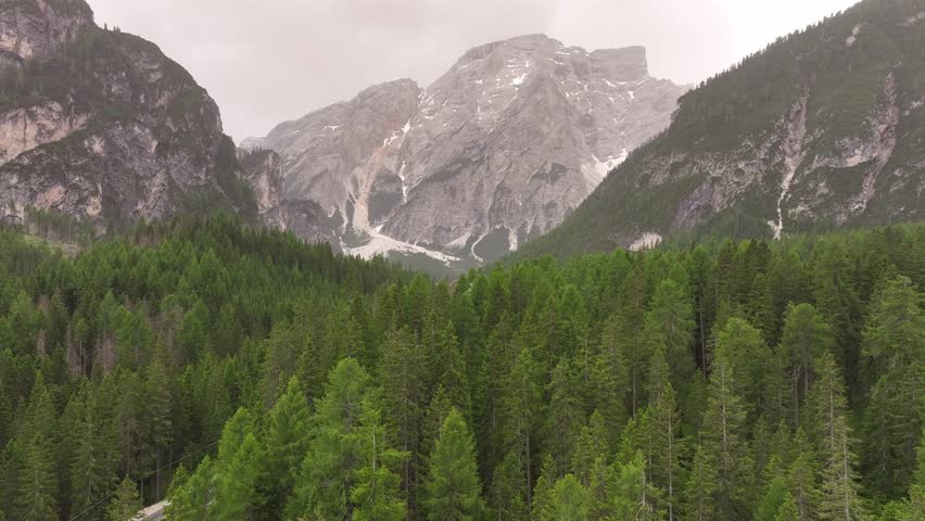 Lake Pragser Wildsee Italy Dolomites mountains valley, aerial evergreen spruce tree forest