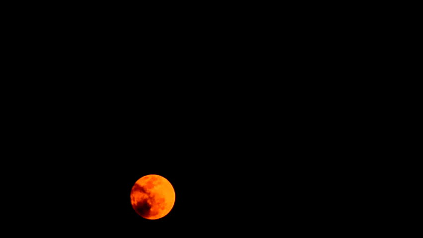 time lapse red moon moving in dark sky