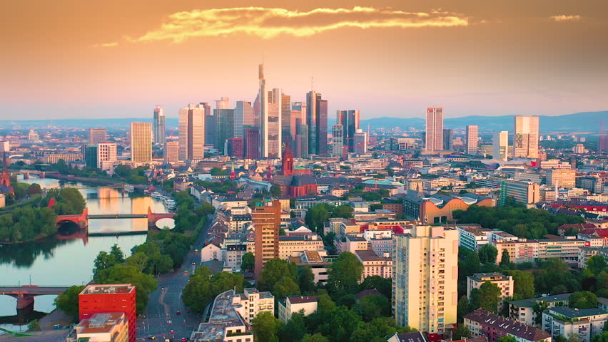 Dolly Flight through Frankfurt am Main, Germany at sunrise. Skyline. New Skyscrapers. Urban Canyon in Sunset or Sunrise Light. Aerial Pedestal in Establishing Night Drone Shot. Frankfurt skyscrapers.