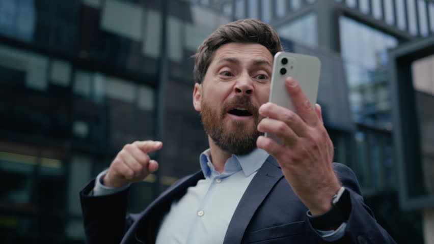 Annoyed mad crazy business man angry furious Caucasian businessman guy male boss employer aggressive irritated talk mobile phone shout scream yell cellphone conflict in city quarrel rage argue outdoor