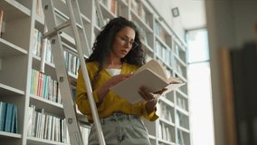 Latina Indian Hispanic woman female student high school university learning girl studying library standing stairs librarian search book textbook pages college teacher learner bookstore buyer archive - Powered by Shutterstock - Get 15% off with code: PIKWIZARD15