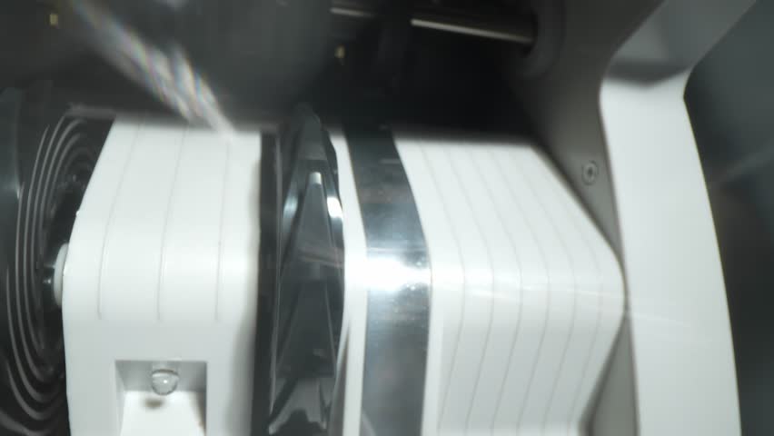 Closeup currency counting machine counting dollar. Slow motion of cash counting machine counts 100 dollar bills USD banknotes. Cash bill counter money machine. Finance banking credit deposit cash.