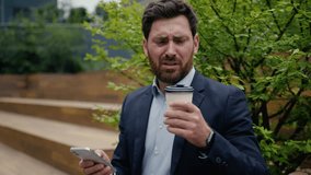 Caucasian man business employer office manager sit outside drinking coffee male guy businessman client entrepreneur using mobile phone in city outdoors bad drink disgust upset with tasteless beverage - Powered by Shutterstock - Get 15% off with code: PIKWIZARD15