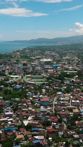 Residential village in Iligan City. Blue sky and clouds. Northern Mindanao, Philippines. Vertical video.