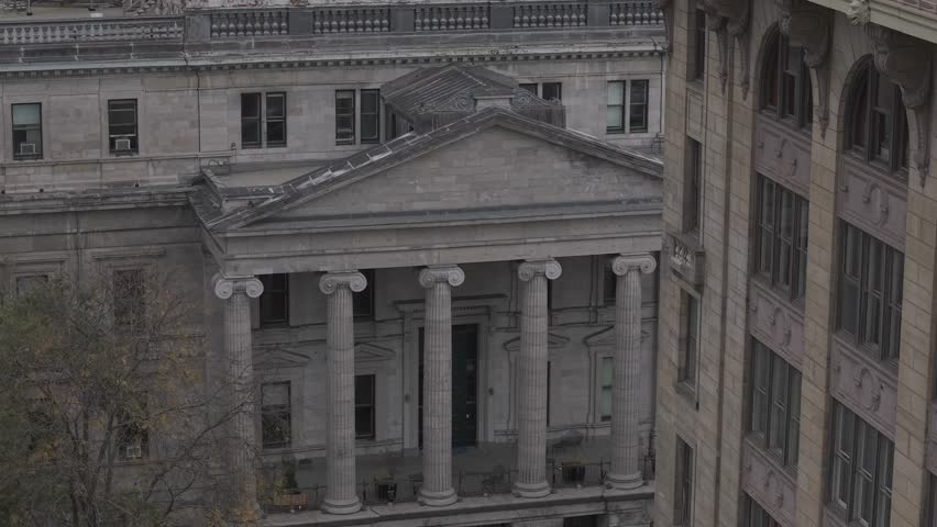 A close-up B-roll shot of the historic Old Montreal Courthouse, captured with a 70mm lens. The footage features a smooth pan from left to right, emphasizing the architectural details of the building