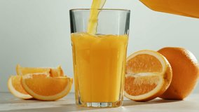 Woman pouring orange grapefruit juice from juicer into glass on colorful background, citrus vitamic c healthy fresh juice in cafe, morning breakfast drink. - Powered by Shutterstock - Get 15% off with code: PIKWIZARD15