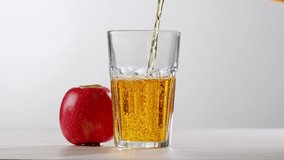 Apple juice or cider is pouring from a bottle into a glass. Fresh drink with apples and pear on an old kitchen table.  - Powered by Shutterstock - Get 15% off with code: PIKWIZARD15