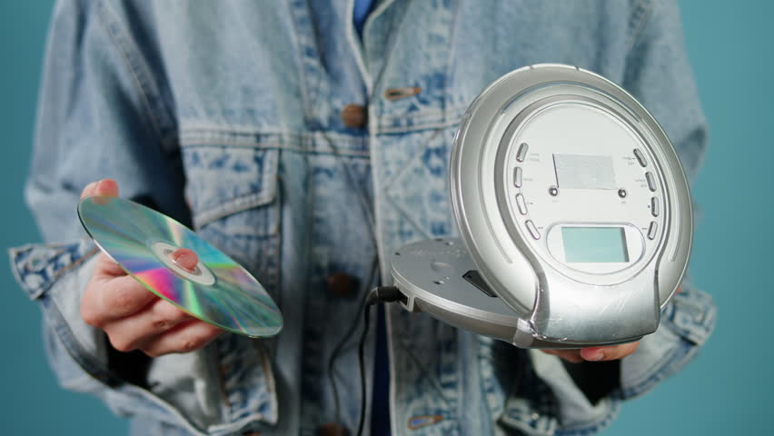 CD Player, Using headphone for old music portable compact player close-up. Listen to music with vintage player. 