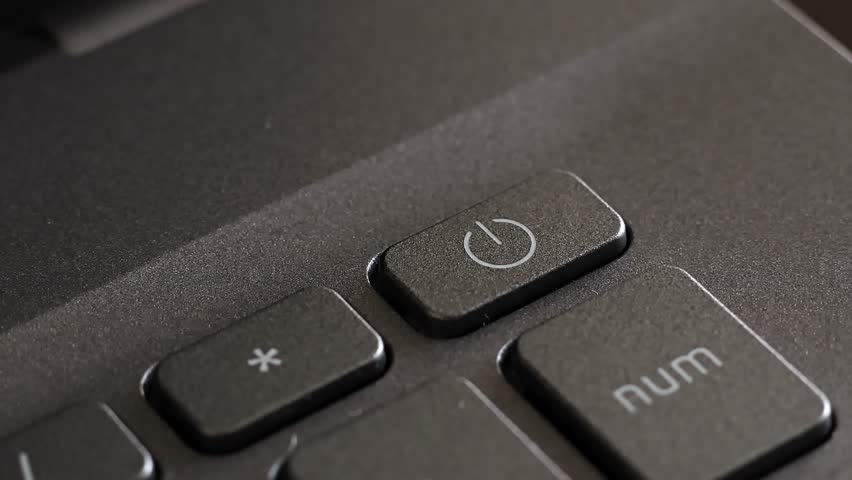 Close up view of index finger pressing laptop power button, notebook keyboard. Turn on the device, digital confirmation, sending email message, start online office work, beginning input data.