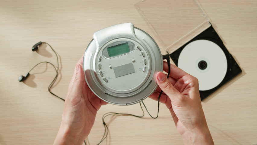 CD Player, Using headphone for old music portable compact player close-up. Listen to music with vintage player. 