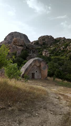 Exploring ancient rock dwellings in the rugged landscape of Sardinia