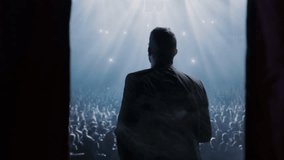 Silhouetted Public Speaker On Stage Addressing Large Concert Arena Crowd Spotlight Success - Powered by Shutterstock - Get 15% off with code: PIKWIZARD15