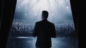 Silhouetted Public Speaker On Stage Looking At Large Audience Leadership Success Presentation - Powered by Shutterstock - Get 15% off with code: PIKWIZARD15