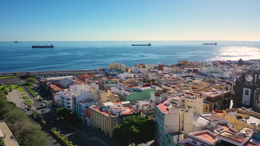 Aerial 4K video from drone to cityscape of Las Palmas , featuring the Cathedral of Santa Ana at sunrise. Las Palmas de Gran Canaria, Canary Islands, Spain
