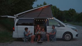 Family on campervan enjoying the outdoors. Family with children having dinner and having fun during vacation - Powered by Shutterstock - Get 15% off with code: PIKWIZARD15