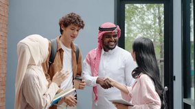 Group of four diverse business people stand talking in their workplace, greeting and Happy confident diverse professional employees talking laughing, Before we shake hands and say goodbye - Powered by Shutterstock - Get 15% off with code: PIKWIZARD15