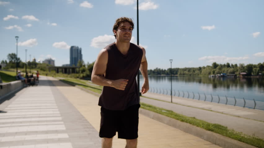 Happy Caucasian man male guy sport sportsman athlete running runner jogger city energy enjoying training healthy activity fitness workout sporty exercise smile cardio strong wellness outside jogging