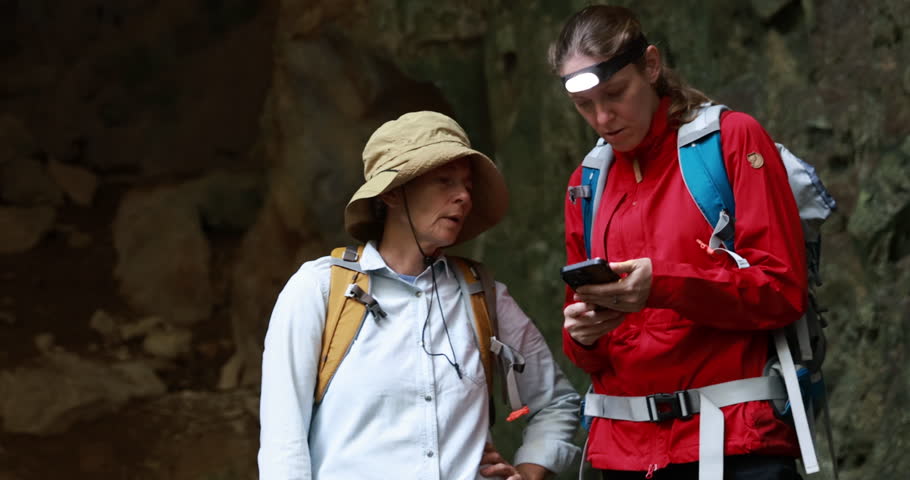 Senior mother and daughter are having a good time in the cave. senior female exploring  in the cave togetherness