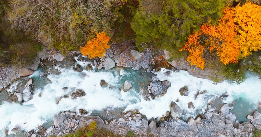 top view of stream flowing in the autumn valley 