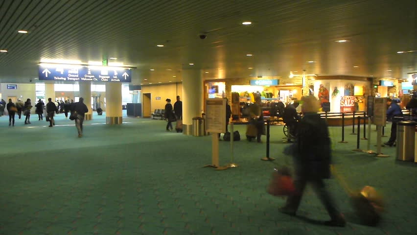 PORTLAND, OREGON - CIRCA 2012: Many people traveling with luggage at Portland