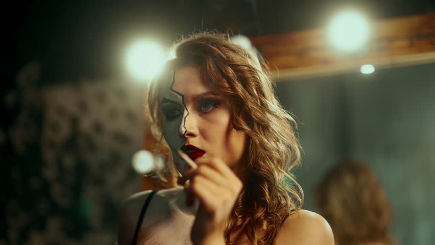 Beautiful lady with art makeup on half of face smoking cigarette, portrait. Self-confident woman wants to be another person or stay herself, pretty ambitious female person playing role for be accepted