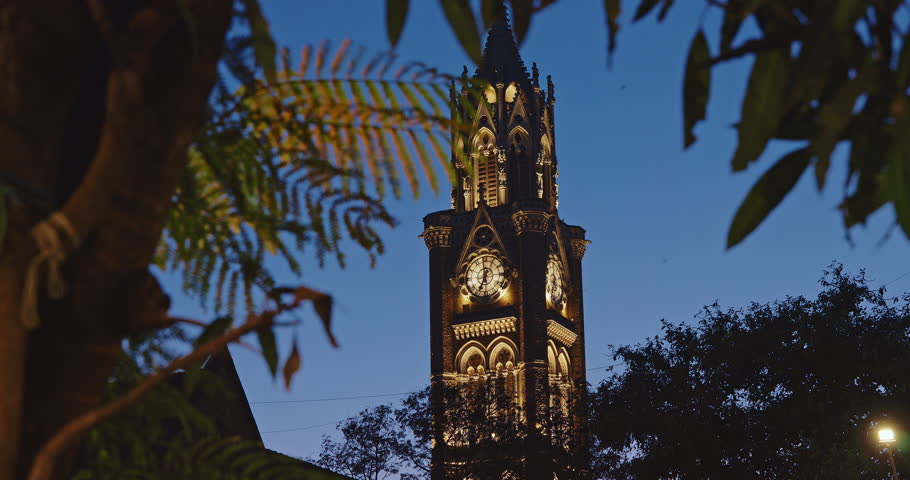 Rajabai Clock Tower In Evening Illumination. Clock Tower In Mumbai India. Confines Of Fort Campus Of University Of Mumbai. Modeled It On Big Ben In London. It Stands At Height Of 85 M Or 280 Ft
