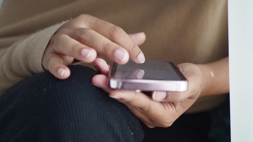 A hand is holding a sleek smartphone, showcasing its impressive features elegantly