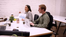 Multiracial team collaborates on a project, analyzing financial data and engaging in productive dialogue in a modern coworking environment - Powered by Shutterstock - Get 15% off with code: PIKWIZARD15