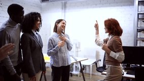 Diverse team of coworkers gathers as their redheaded colleague leads a team building activity. Laughter and smiles abound as they engage in a positive and inclusive work environment - Powered by Shutterstock - Get 15% off with code: PIKWIZARD15
