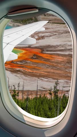 aerial view of Yellowstone National Park, Wyoming, United States of America. Grand Prismatic Spring in Yellowstone National Park seen from above through the airplane window. Vertical portrait format