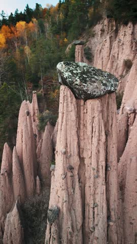 4k video of Earth pyramids nestled in a pine forest, Dolomites, Italy