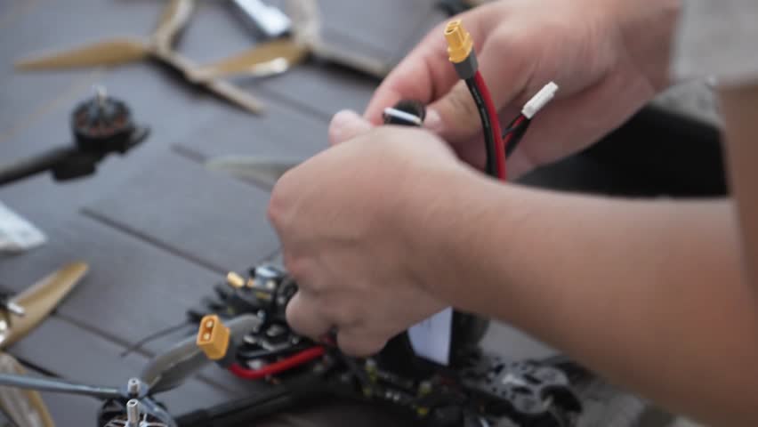 A man prepares an FPV drone before a flight
