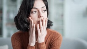 Thoughtful sad female feels depressed sitting in living room at home. Upset lonely woman thinking about her problems. Young adult lady is tired, unhappy, disappointed and has a bad mood. Close up - Powered by Shutterstock - Get 15% off with code: PIKWIZARD15