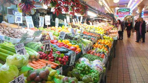SEATTLE, WASHINGTON - CIRCA 2012: Public market interior at Pike's Place Market fruit and vegetable stand. Editorial Stock Video