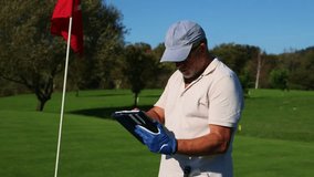 senior golfer focuses on using a tablet to record scores during a tournament, showcasing how modern technology integrates with traditional sports to enhance the game - Powered by Shutterstock - Get 15% off with code: PIKWIZARD15