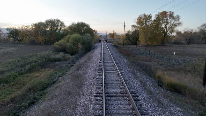 flying over single railroad track, fall scenery at dusk in northern Colorado