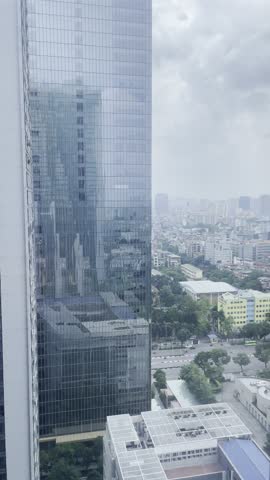 Hanoi, Vietnam - June 16, 2023: Aerial view of Hanoi’s sprawling cityscape from atop a high-rise. Buildings, streets, and greenery stretch across the horizon, showcasing the city’s vibrant urban lands