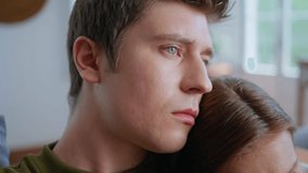 Sad man bonding girlfriend watching movie at couch closeup. Serious guy embracing unknown girlfriend. Relaxed couple looking tv program online blog on comfortable sofa. Pair romantic date at home  - Powered by Shutterstock - Get 15% off with code: PIKWIZARD15